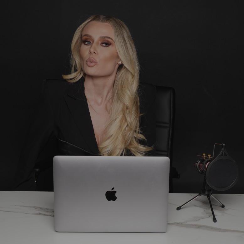 Natalie Dawson sitting at her computer with a microphone