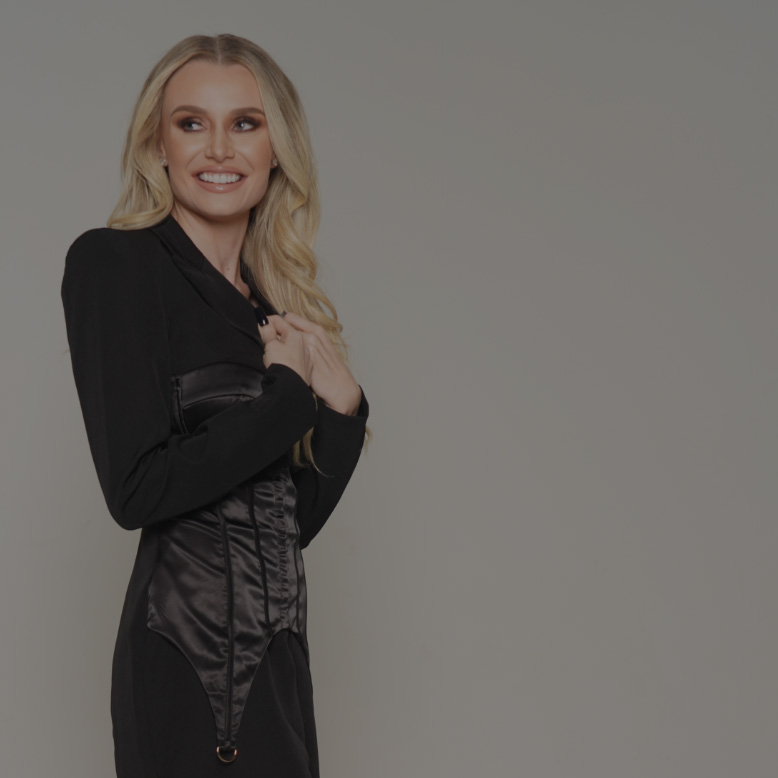 Natalie Dawson adjusting the lapel on her black dress